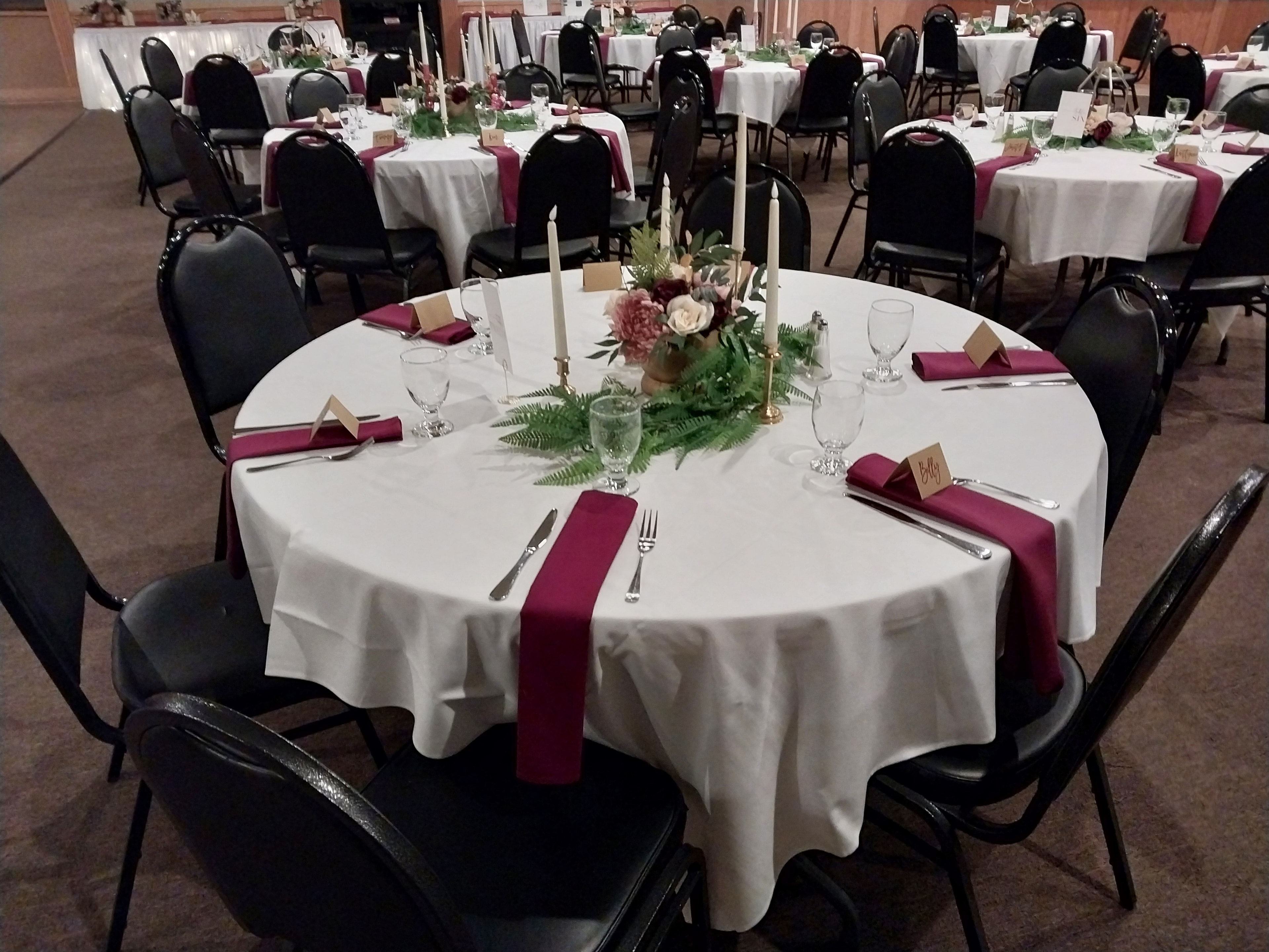 Elegant banquet hall table setting with centerpieces and warm lighting