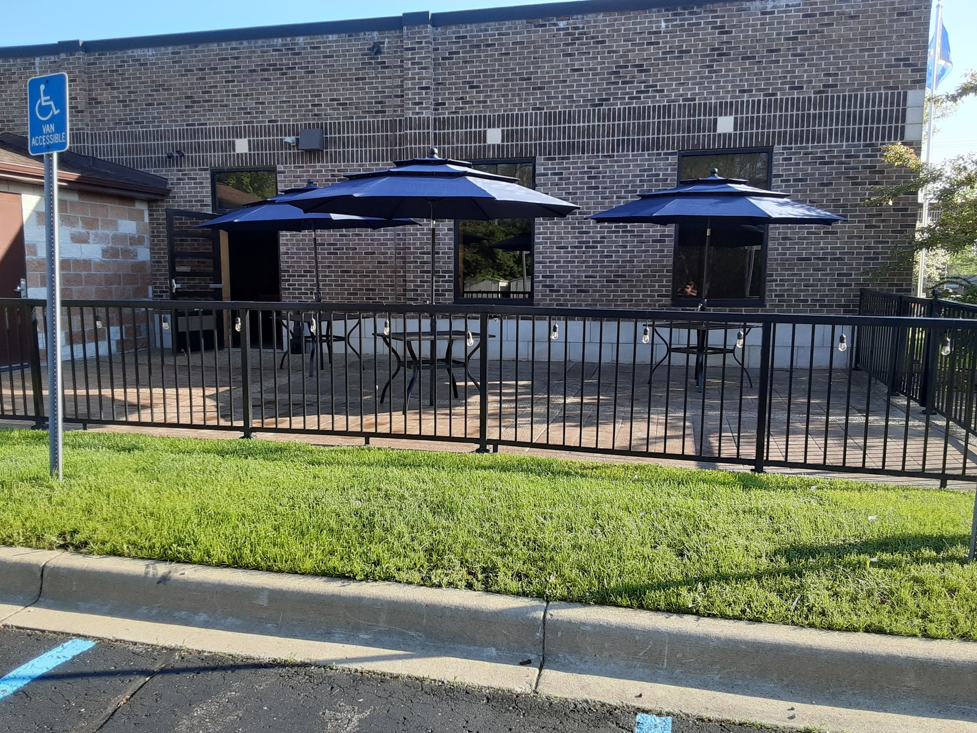 Outdoor patio area with blue umbrellas and seating
